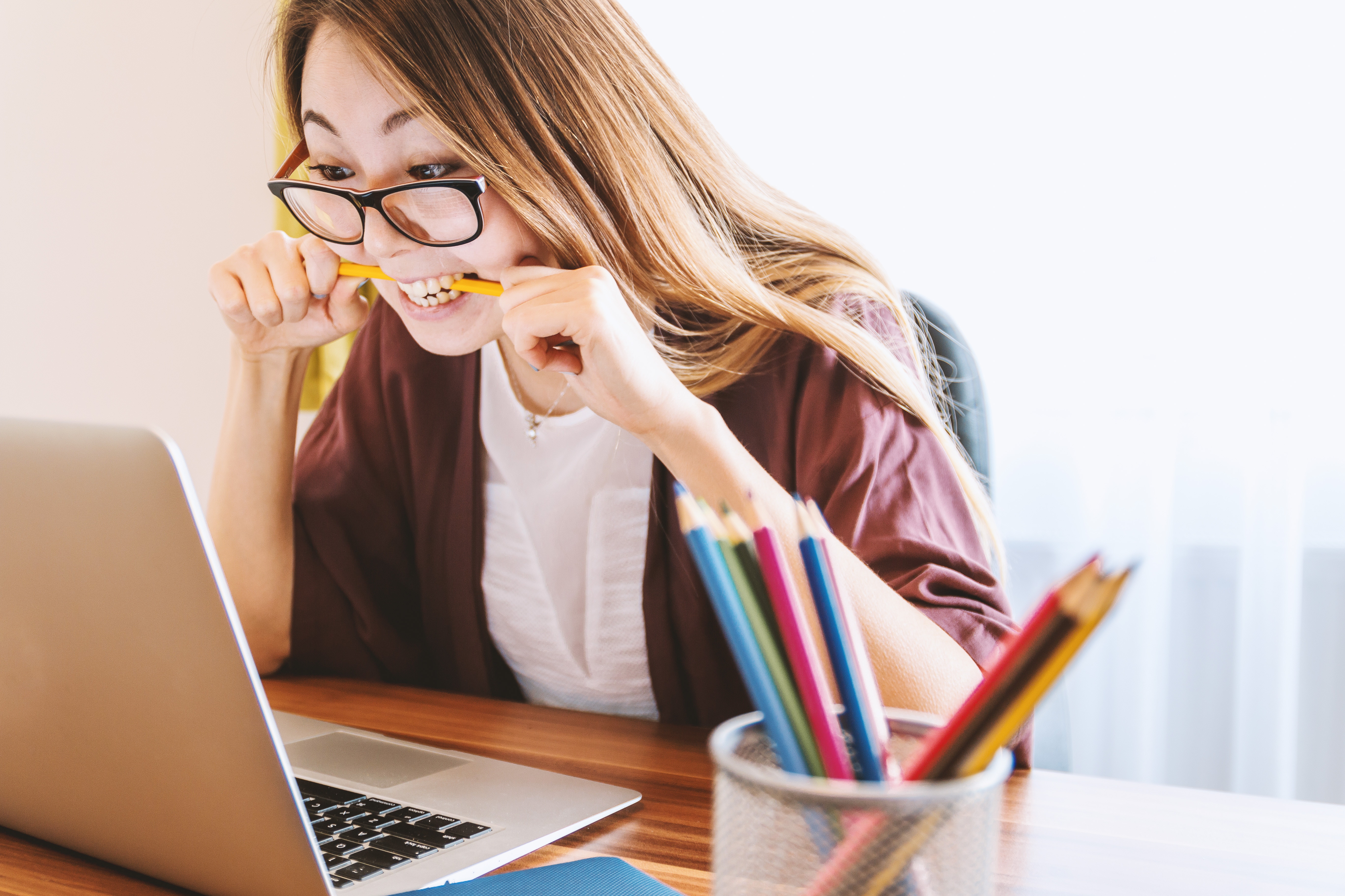 woman biting a pencil - frustration - incident tasks