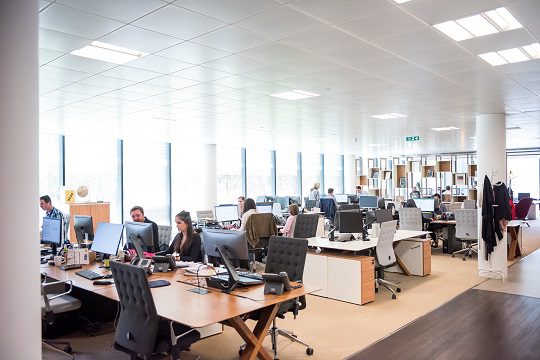 Open plan office space with workers