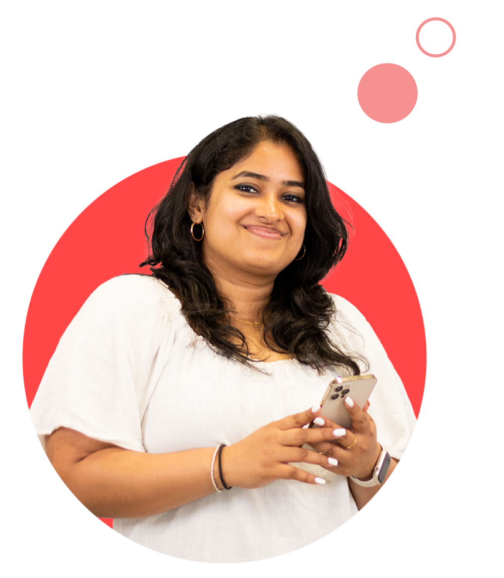 Female colleague smiling and holding phone with both hands in red circle