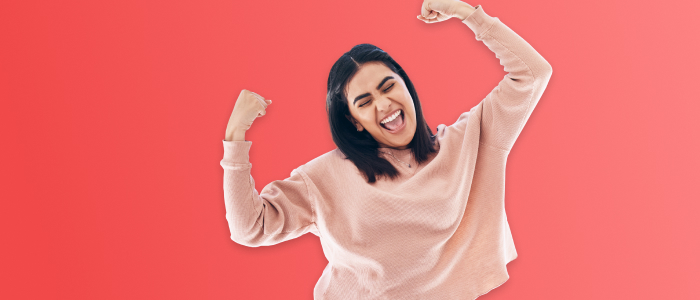 Woman cheering on red background