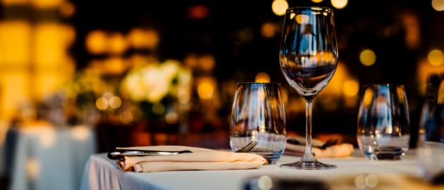 Chic dinner table setting with wine glass, napkins, etc.