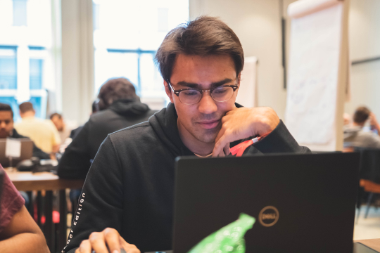 Male employee behind his laptop focusing on work