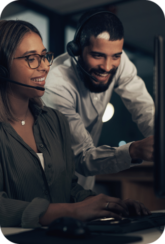 men and woman behind computer with headset