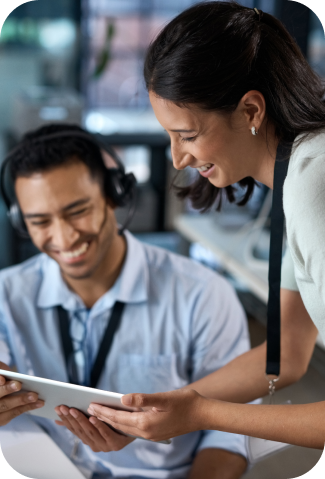 IT employees, man and woman, discussing st shown on a tablet