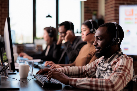 visual of people working and looking at a screen. also the feature image for GenAI Service Management blog