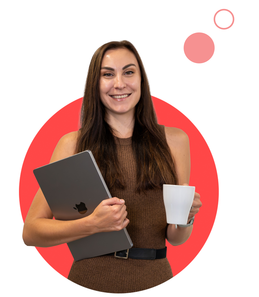 Colleague smiling while holding a laptop and a cup