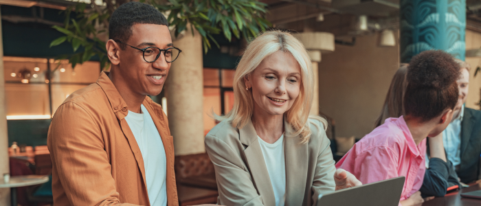 image of man and woman looking happily at a laptop screen