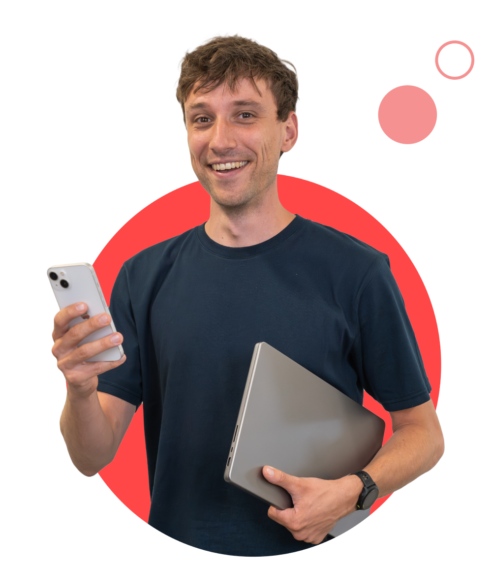 employee smiling with phone and laptop