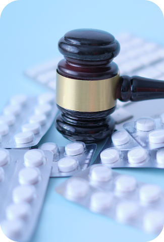 gavel and pills on blue background medical crim