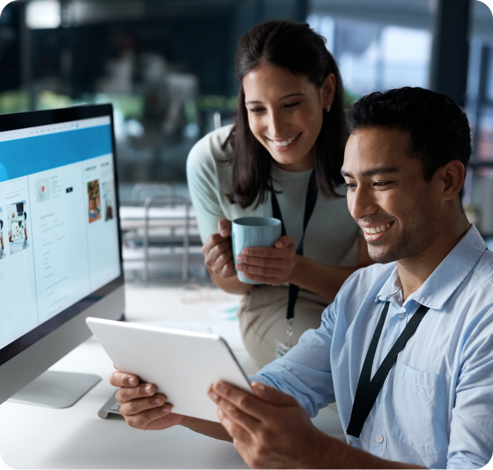 two people looking at a tablet in a working environment