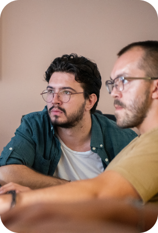 two man with glasses looking at a case