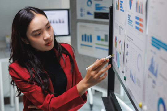 Woman pointing at data on a digital screen